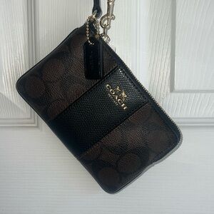 Coach NWT wristlet. Black and brown with gold zipper